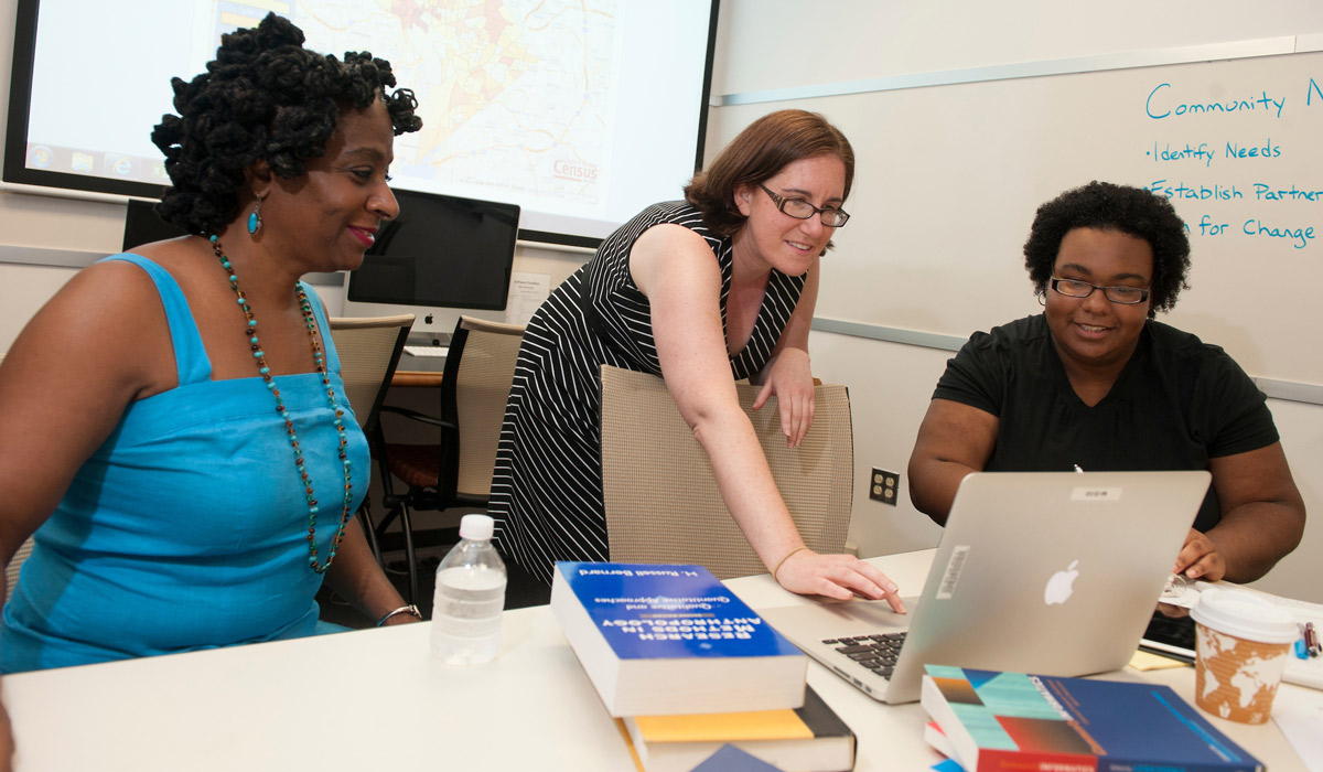 Students looking at computer